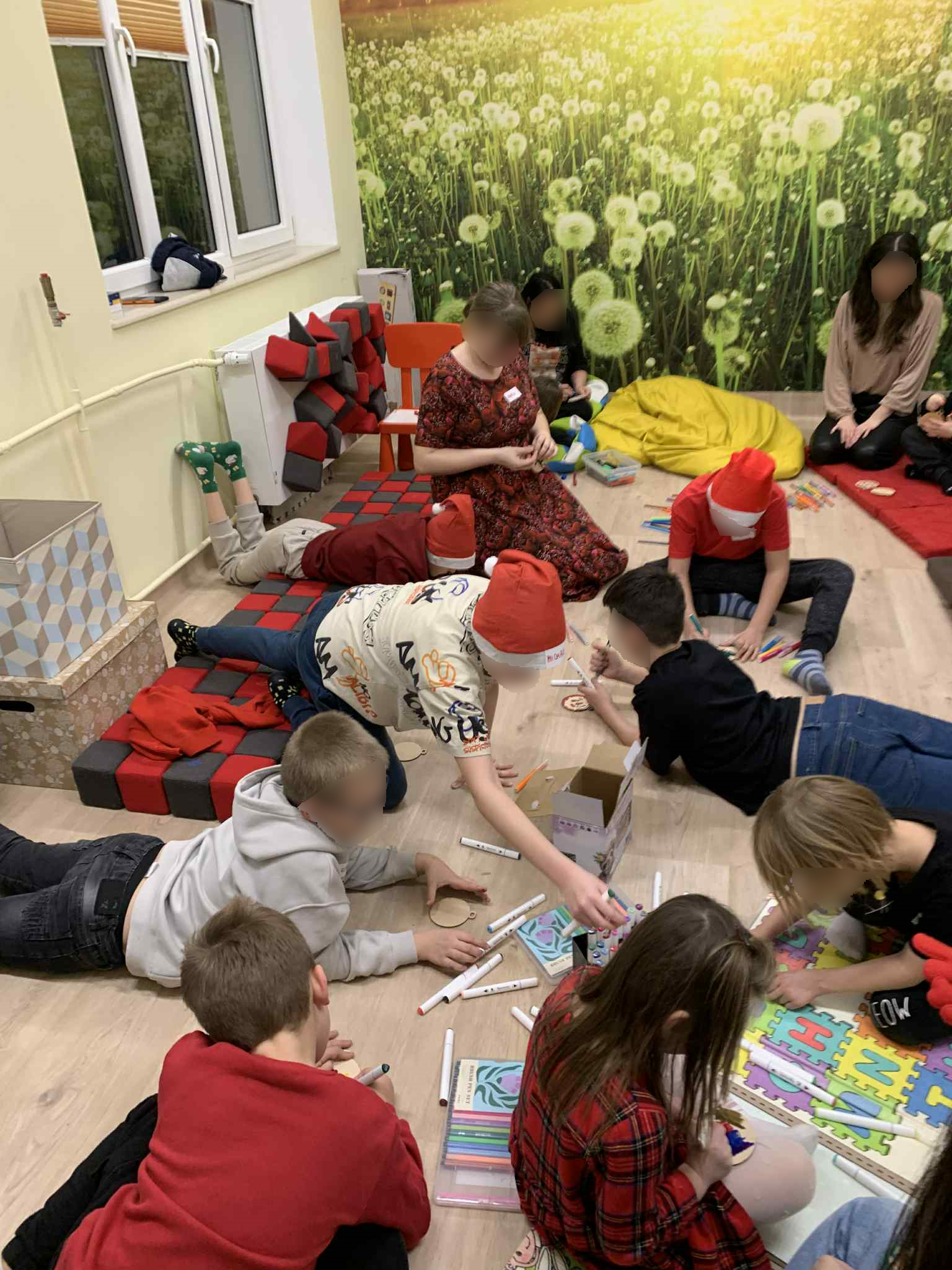 Impreza Mikołajkowa na sali pełnej dzieci, choinka rozdawanie prezentów, warsztaty